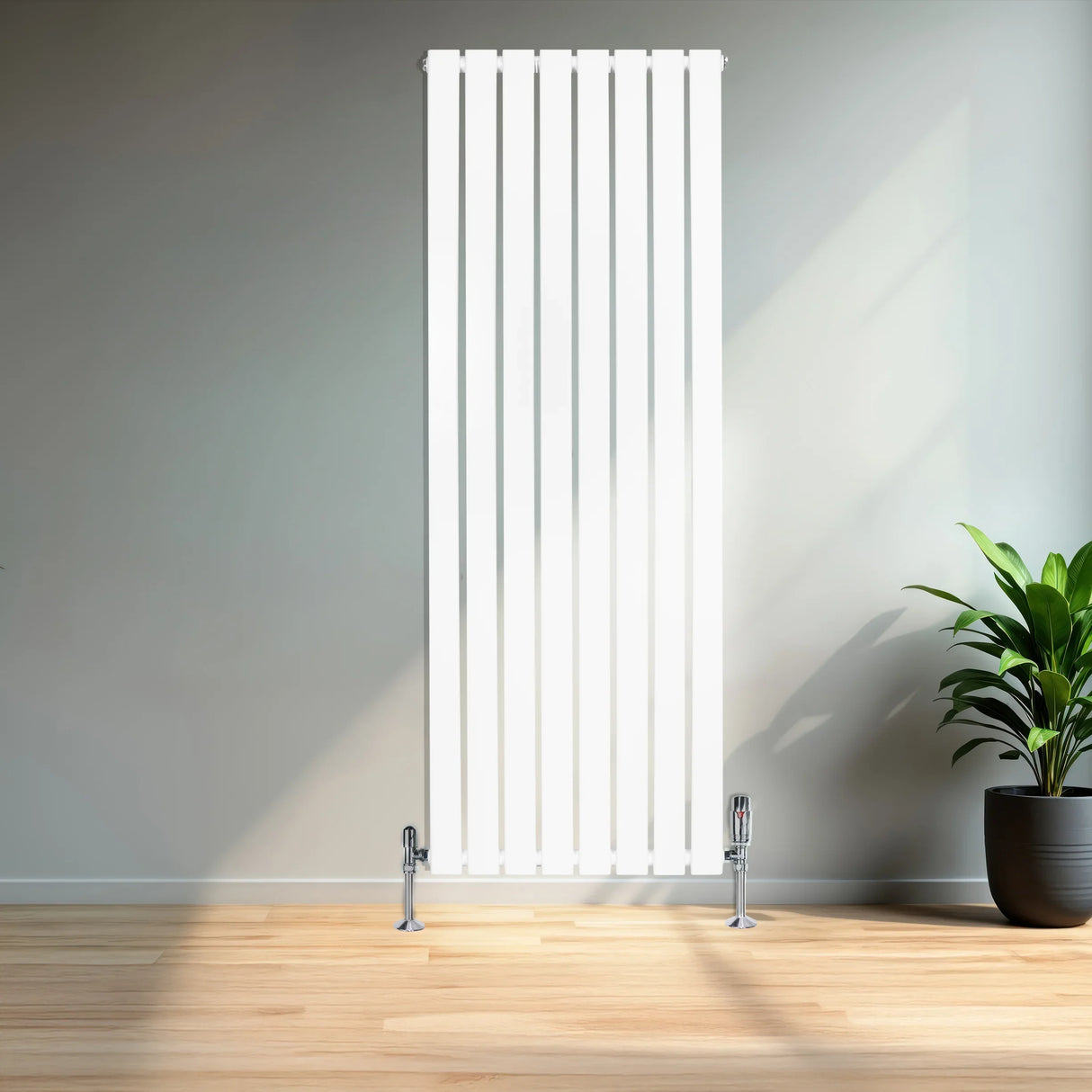 Sleek white flat single column radiator with vertical slats, measuring 1600mm x 560mm, complemented by chrome valves in a modern room setting