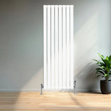Sleek white flat single column radiator with vertical slats, measuring 1600mm x 560mm, complemented by chrome valves in a modern room setting