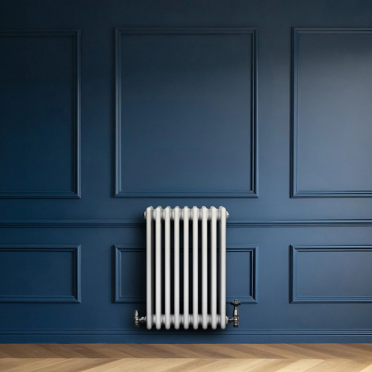 Traditional white 4 column radiator with valves, mounted against a deep blue wall, showcasing a sleek, modern design and smooth finish