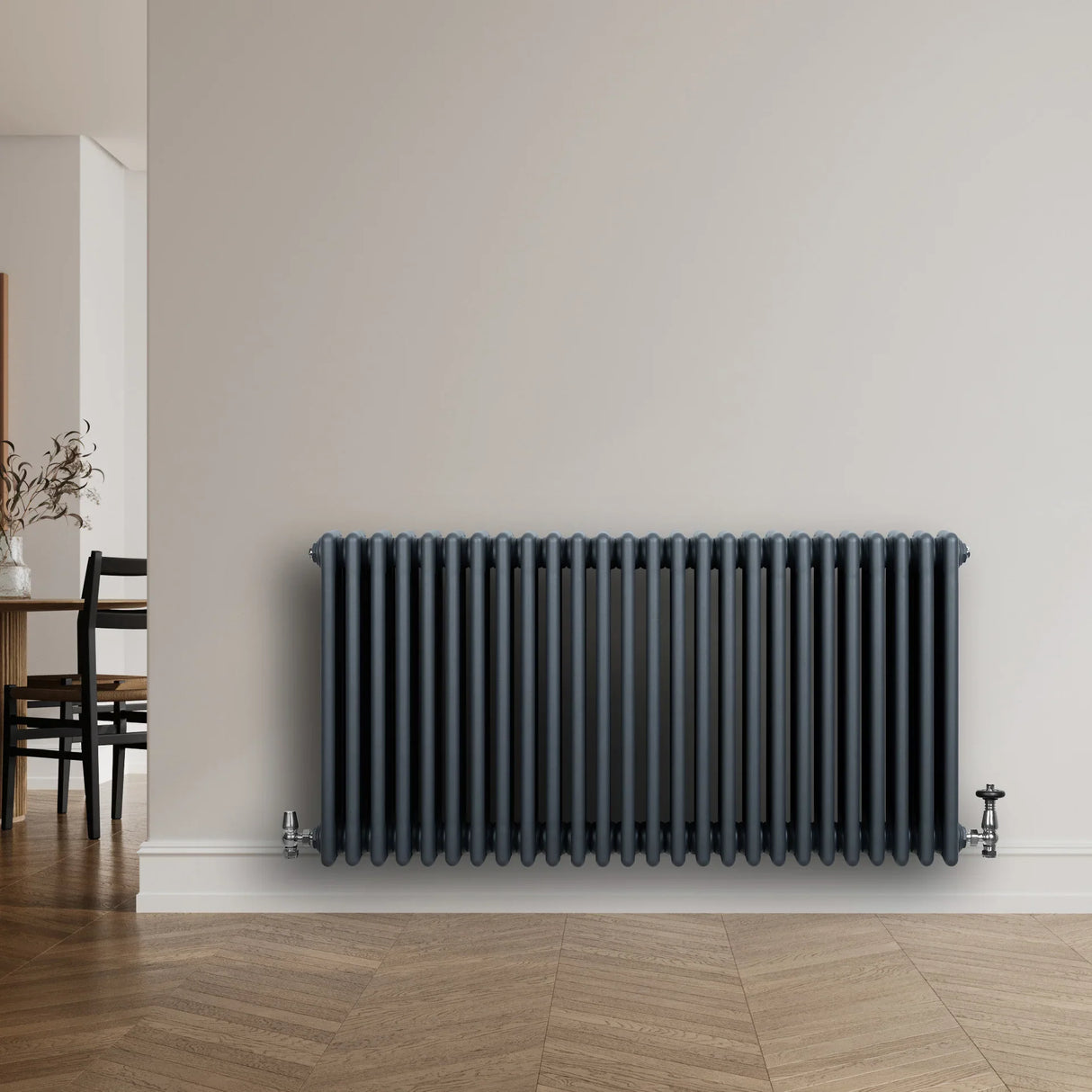 Traditional anthracite grey 4 column radiator with sleek vertical lines, mounted on a light wall, complementing modern decor