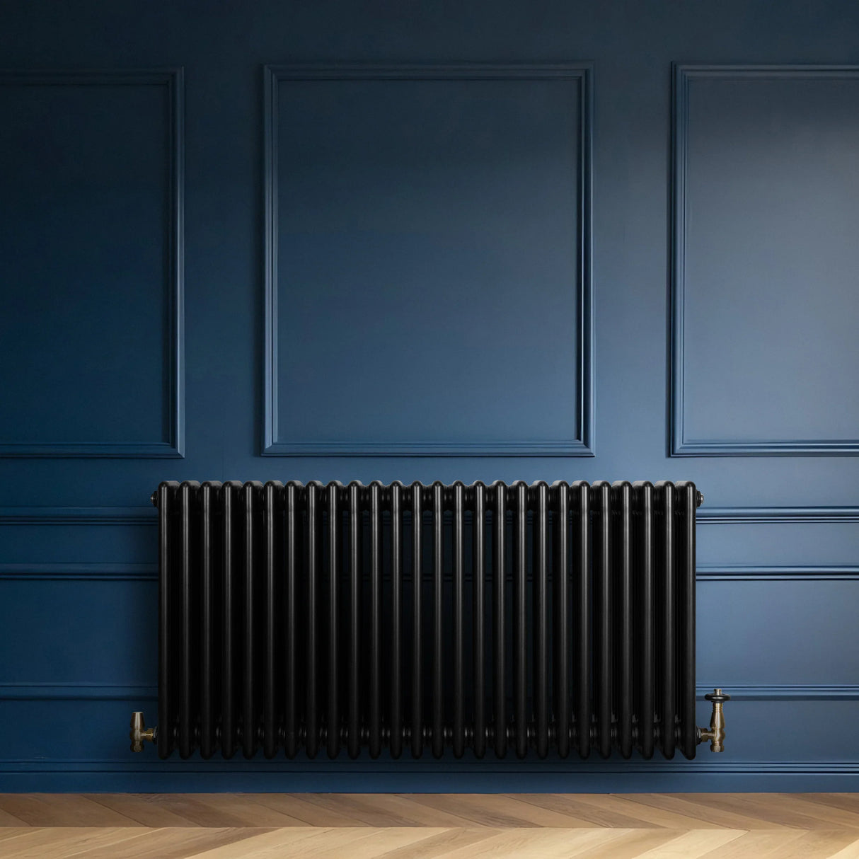 Traditional black 4 column radiator with brass valves, mounted against a deep blue wall, showcasing a sleek, modern design