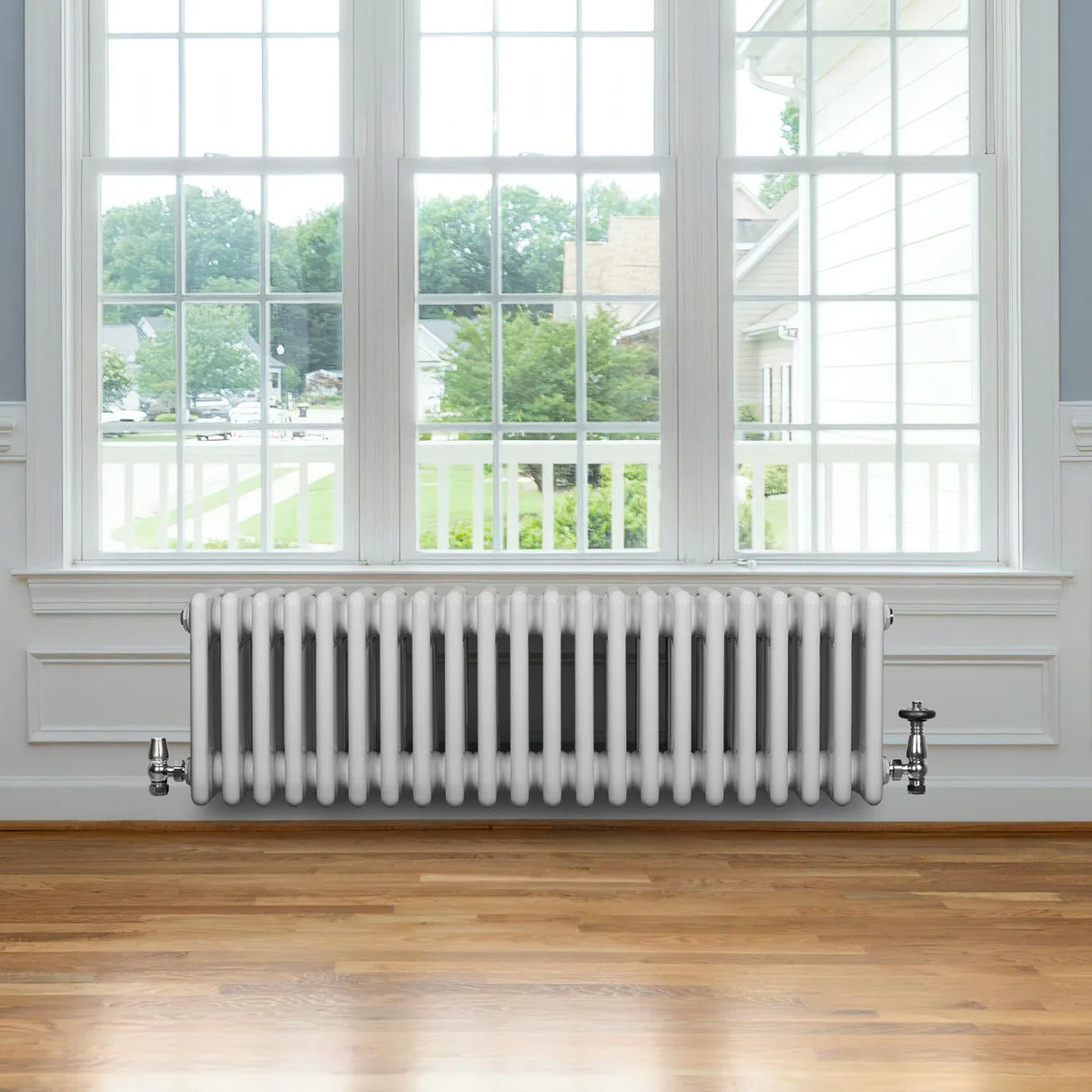 Traditional 4 column radiator in white, 300 x 1010mm, featuring a sleek design and smooth finish, installed beneath a large window