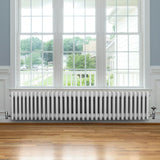 Traditional 4 column radiator in white, 300 x 1505mm, featuring a sleek design with smooth, glossy finish, placed under a large window