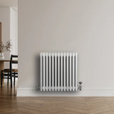 Traditional white 4 column radiator, 600 x 605mm, featuring a sleek design with smooth, glossy finish and chrome valves against a neutral wall