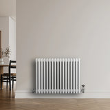Traditional 4 column radiator in white, 600 x 785mm, featuring a sleek, smooth finish and mounted against a neutral wall in a modern room