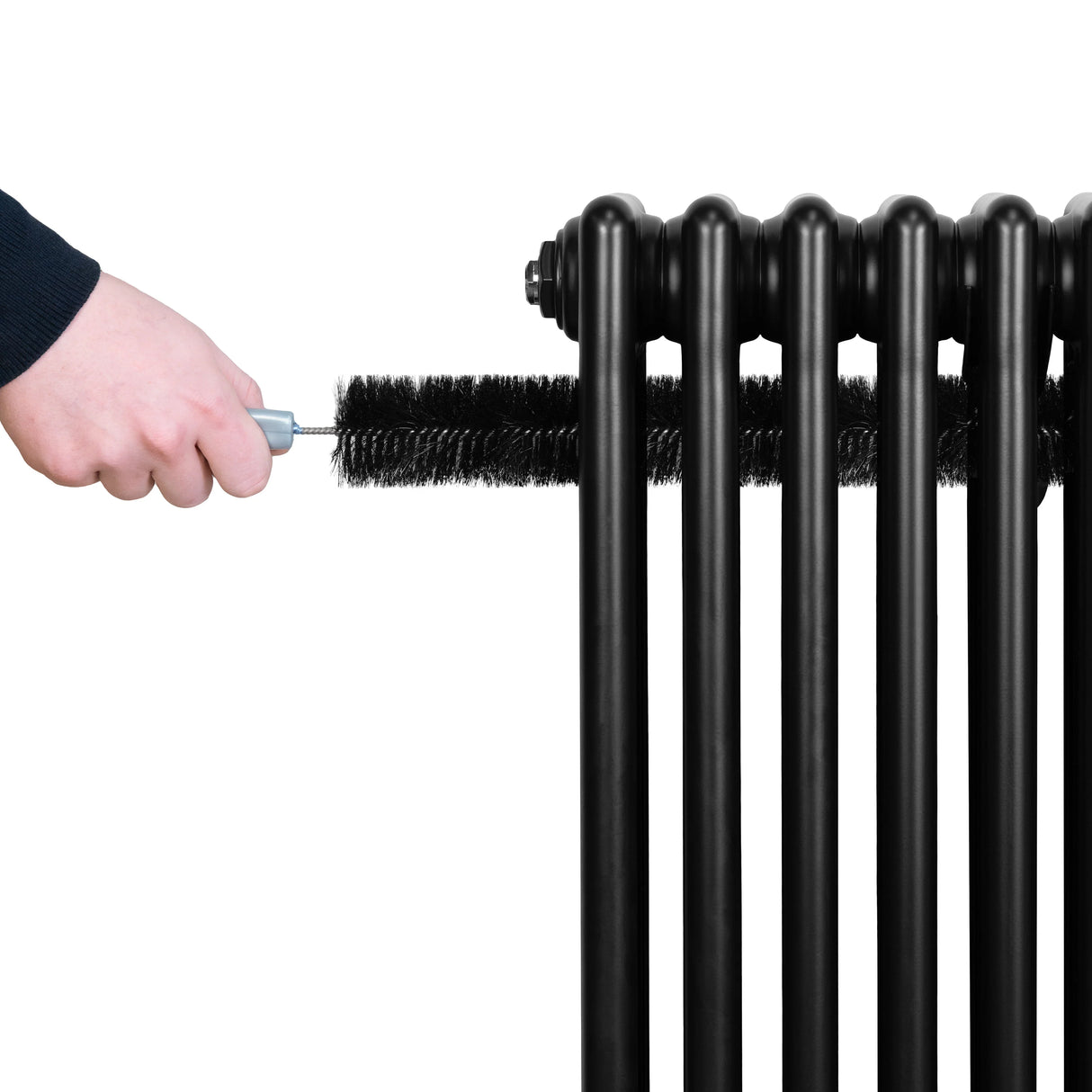 Traditional black 4 column radiator with a hand using a brush for cleaning, showcasing its sleek design and sturdy structure