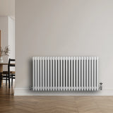 Traditional 4 column radiator in white, 600 x 1190mm, featuring a sleek design with smooth, glossy finish against a modern interior backdrop