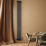 Traditional 4 column radiator in anthracite grey, featuring a sleek vertical design, mounted on a warm-toned wall with elegant decor