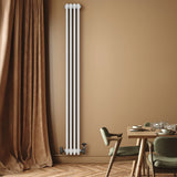 Traditional white 4 column radiator, 1800 x 200mm, mounted on a wall in a warm-toned room with wooden flooring and a dining table