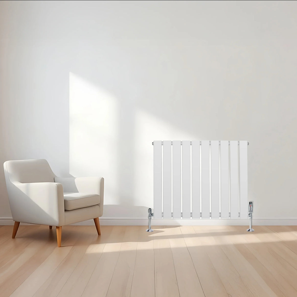 Flat single column radiator in white, 600mm x 700mm, with sleek vertical bars, positioned beside a modern armchair in a bright room