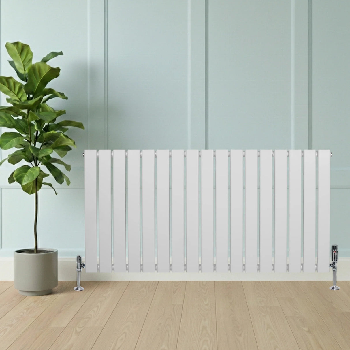 Flat single column radiator in sleek white finish, 600 x 1190mm, with vertical slats and chrome valves, positioned beside a potted plant on wooden floor