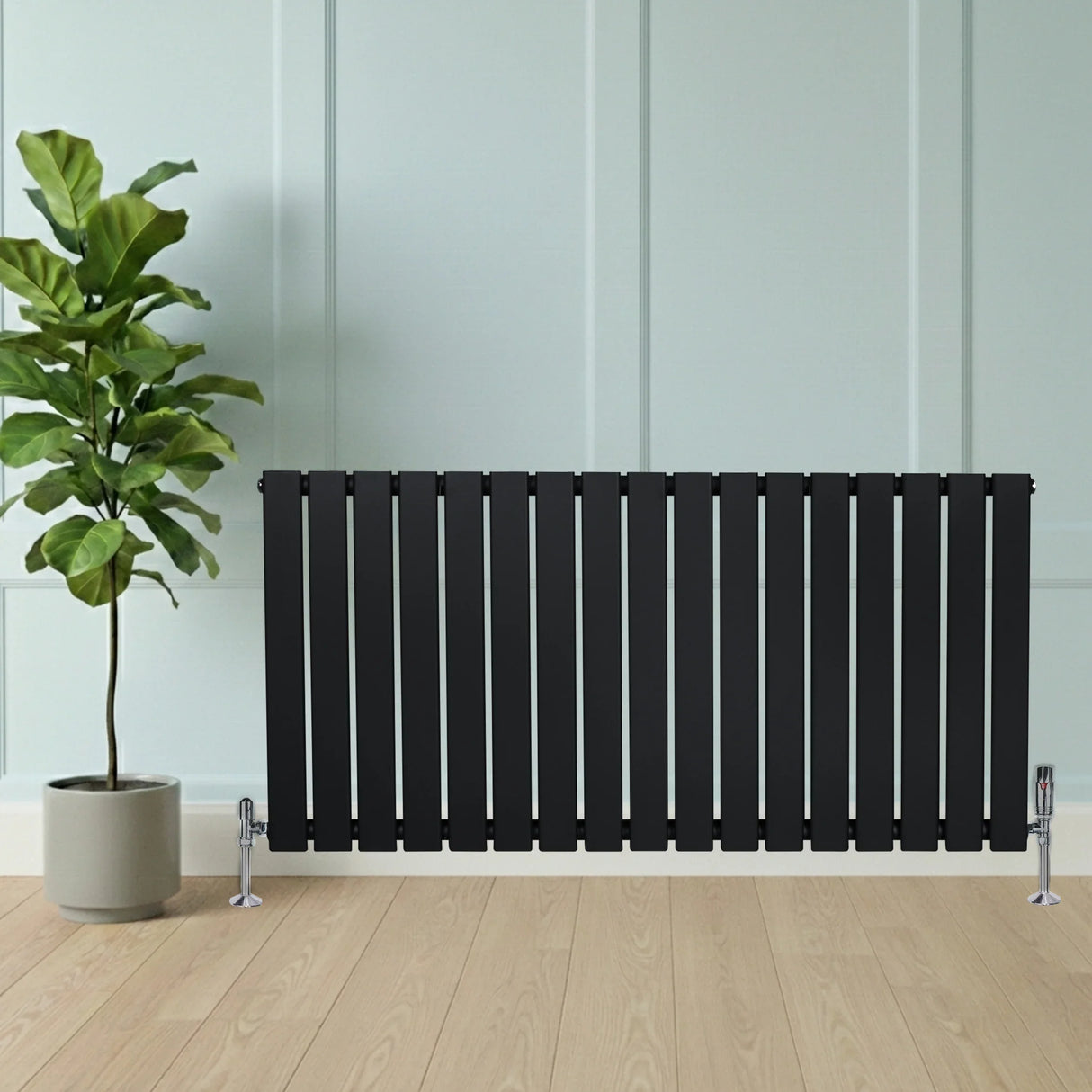 Flat black single column radiator, 600 x 1190mm, featuring sleek vertical slats, positioned beside a potted plant on wooden flooring