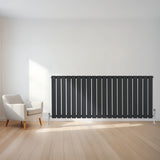 Flat single column radiator in anthracite grey, 600 x 1400mm, featuring vertical slats and sleek design, positioned beside a modern chair