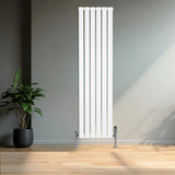 Flat white single column radiator, 1600 x 420mm, sleek vertical design with chrome valves, set against a modern interior backdrop