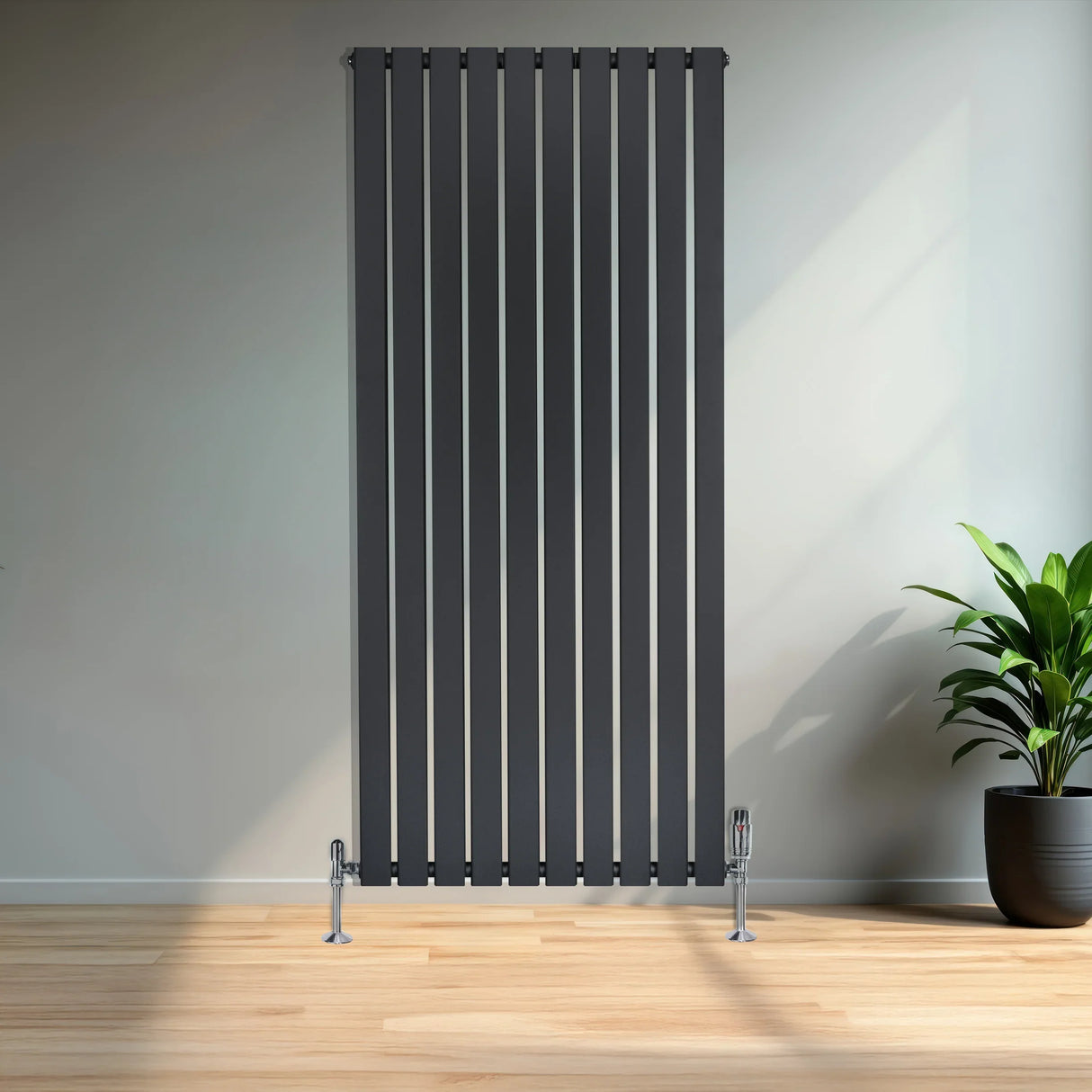 Flat single column radiator in anthracite grey, featuring sleek vertical lines and chrome feet, set against a modern interior backdrop