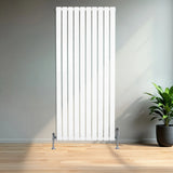 Sleek white flat single column radiator, 1600 x 700mm, featuring vertical lines and chrome valves, set against a modern interior with a potted plant