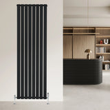 Flat single column radiator in sleek black finish, measuring 1800 x 560mm, mounted on a modern wall in a stylish interior setting