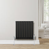 Sleek black oval single column radiator, 600 x 600mm, mounted on a wall with chrome valves, enhancing modern interior decor