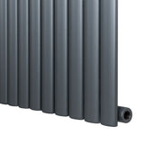 Oval single column radiator in anthracite grey, featuring a sleek design with smooth, matte finish and rounded edges, ideal for modern interiors