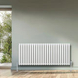 Oval single column radiator in white, 600 x 1440mm, featuring a sleek design with vertical fins, mounted on the wall in a modern interior setting