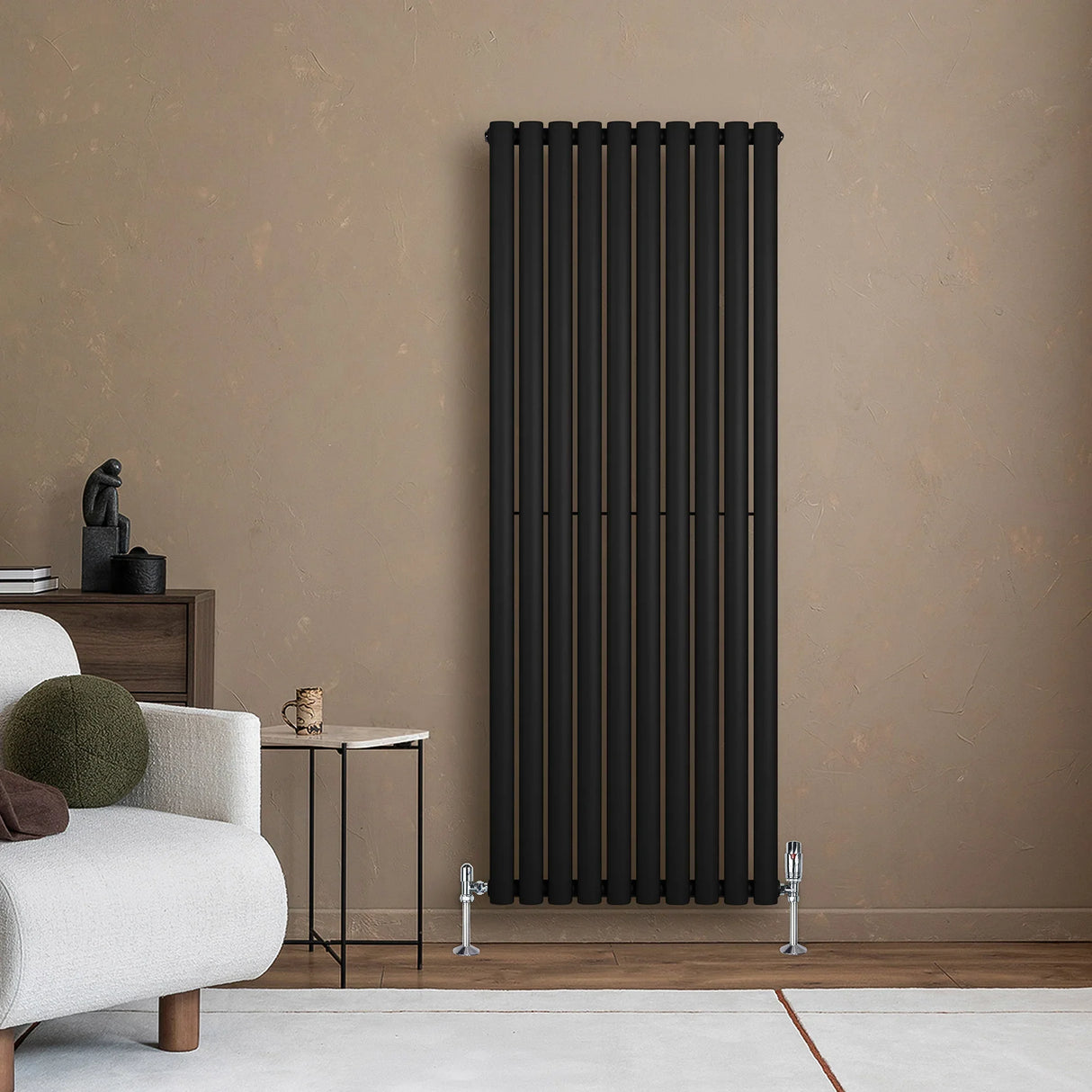 Sleek black oval single column radiator mounted on a textured beige wall, complementing modern decor with clean lines and a minimalist design