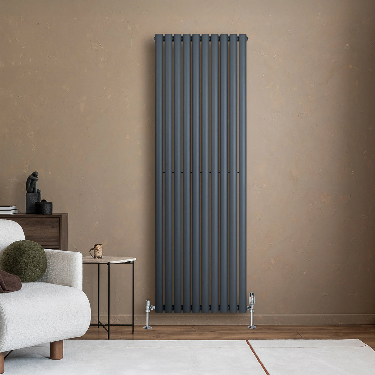 Anthracite grey oval single column radiator, 1800 x 600mm, mounted on a textured wall, complementing modern living room decor