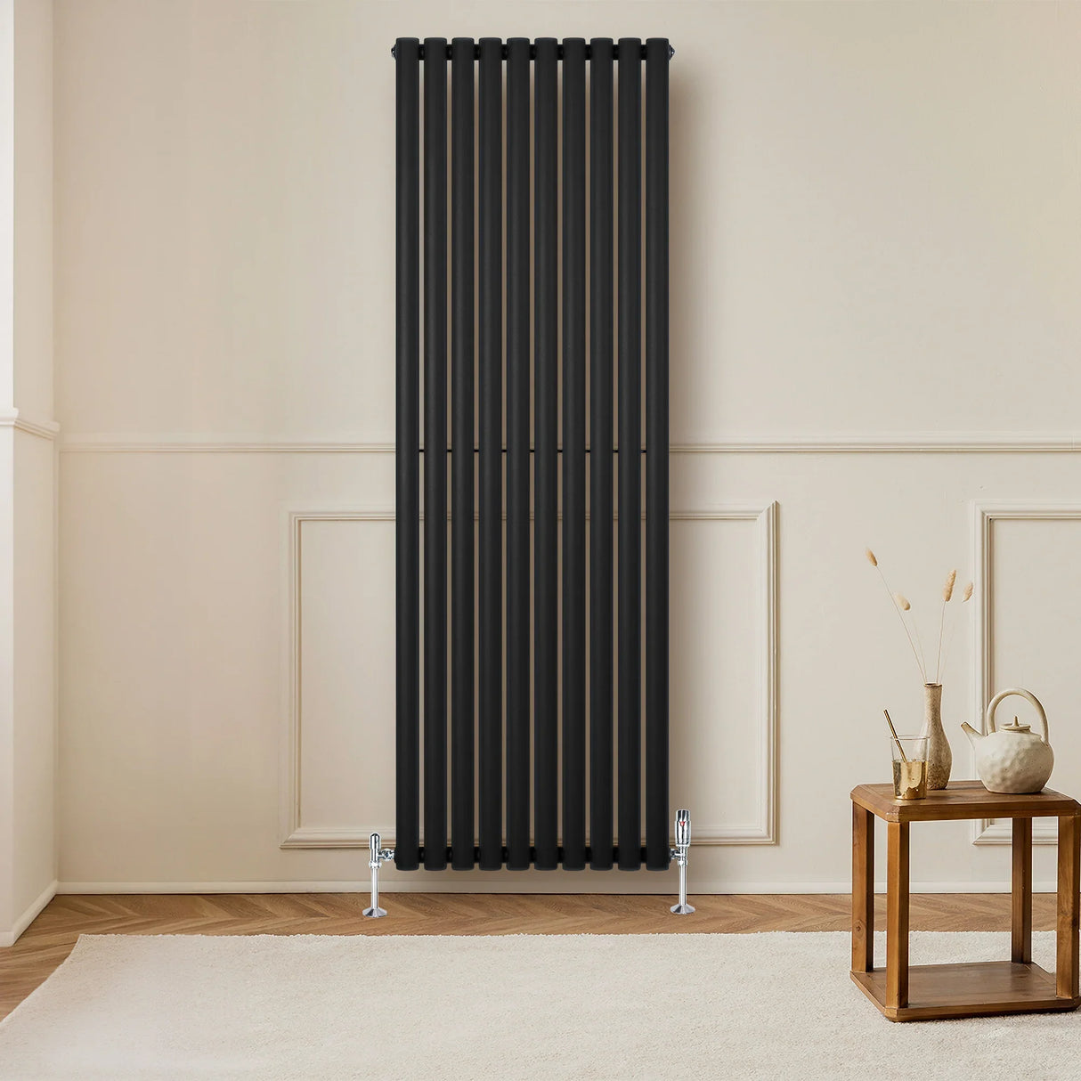 Sleek black oval single column radiator, 1800 x 600mm, mounted on a light wall, complementing a modern interior with wooden flooring