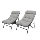 Two grey cushioned lounge chairs with black metal frames, featuring a modern design and soft, textured upholstery for comfort