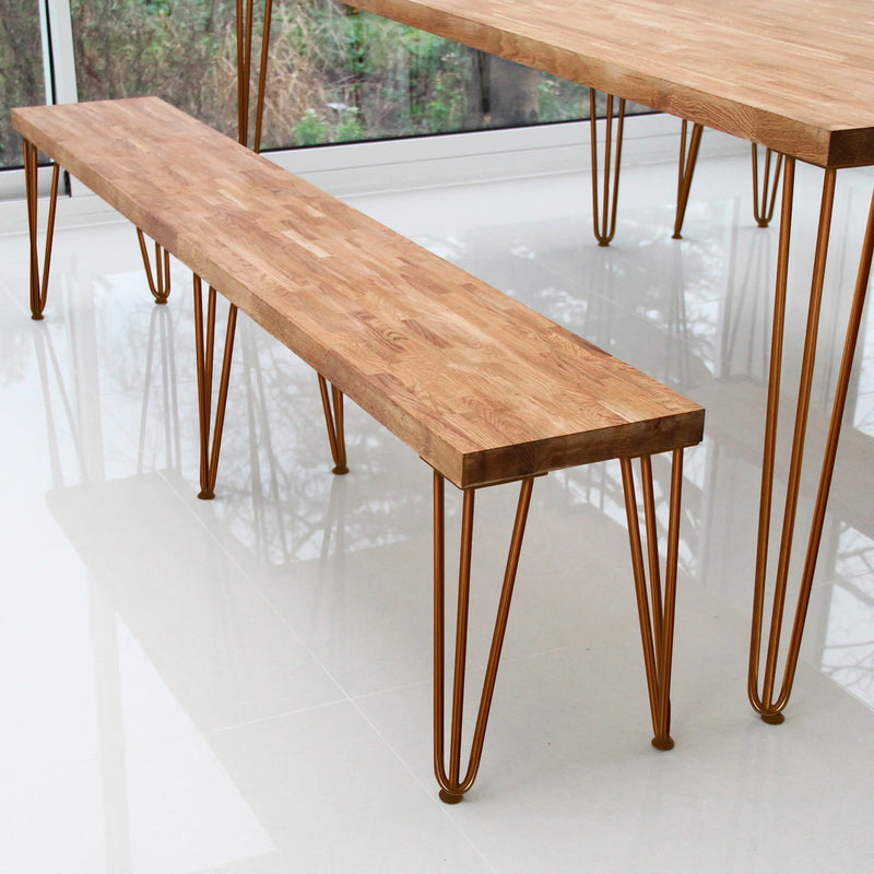 Rustic wooden bench with a smooth, natural finish and slender, curved metal legs, perfect for modern dining or living spaces