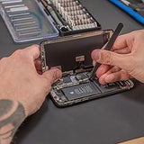 Hands using a precision screwdriver from the ilabPRO 90 Piece Set to repair a smartphone, showcasing tools on a work surface