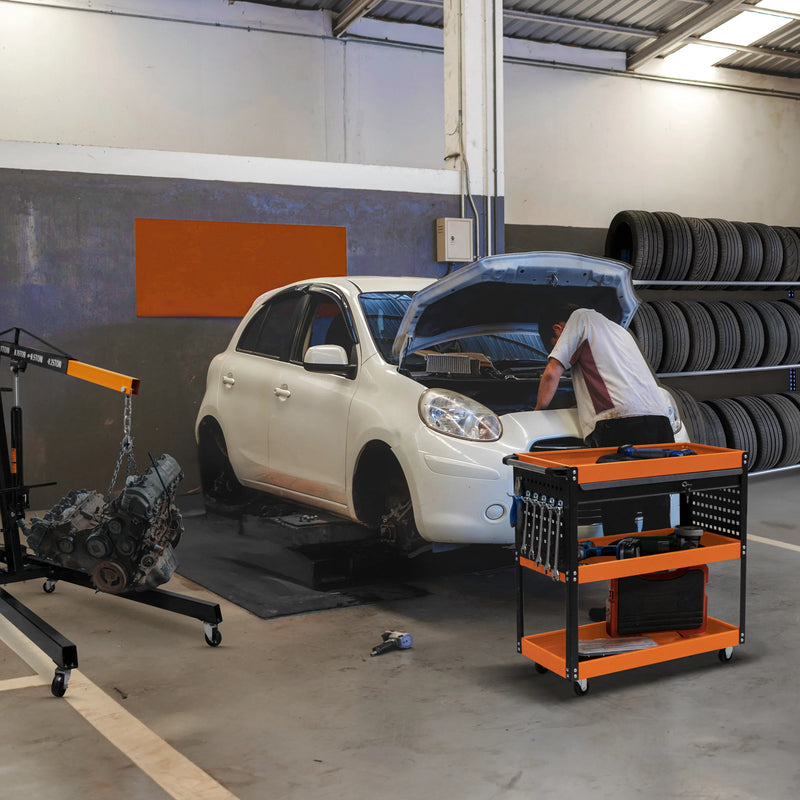 White car on a lift in a garage, mechanic working on the engine, tools organized on an orange and black tool cart, tires stacked in background