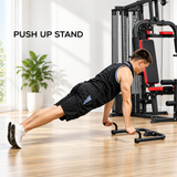 A person performs push-ups on a sturdy black push-up stand in a bright room with a multi-gym workout station in the background